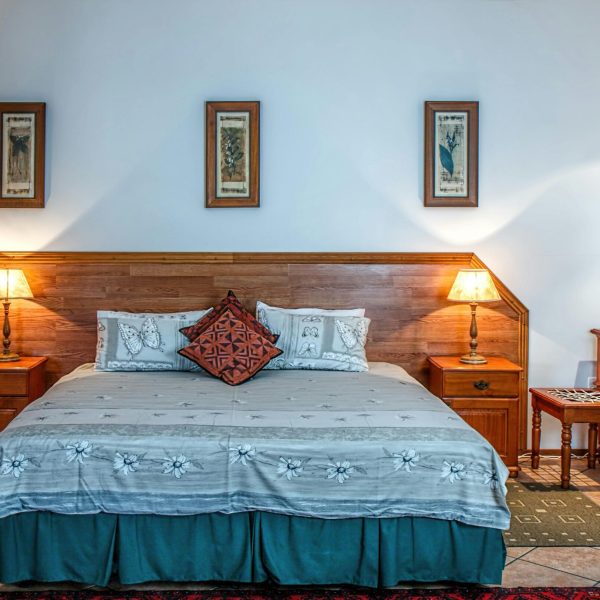 Stylish bedroom featuring wooden furniture and soft lighting for a warm ambiance.